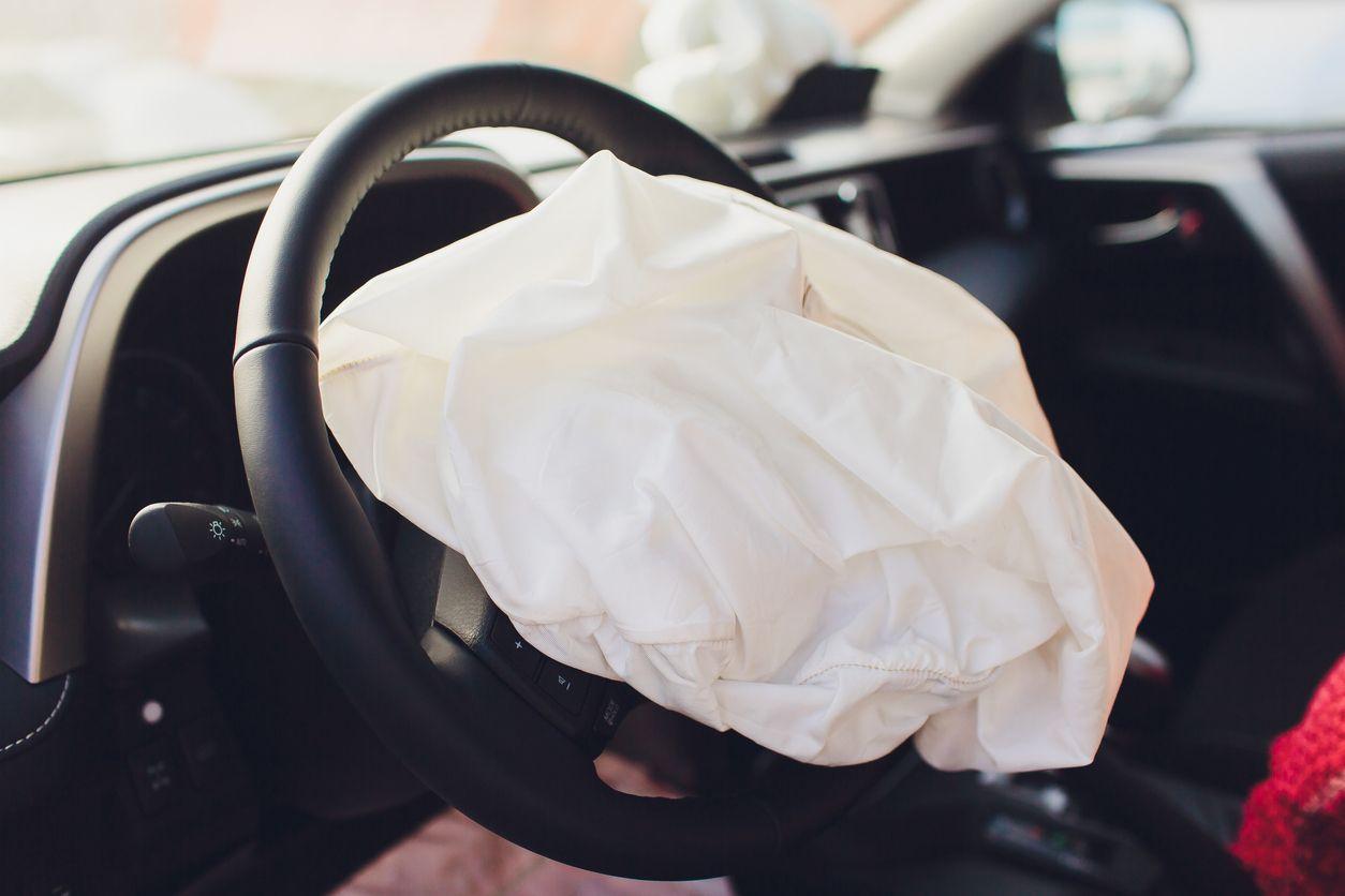 Close-up of a deployed airbag in a car, highlighting safety features.