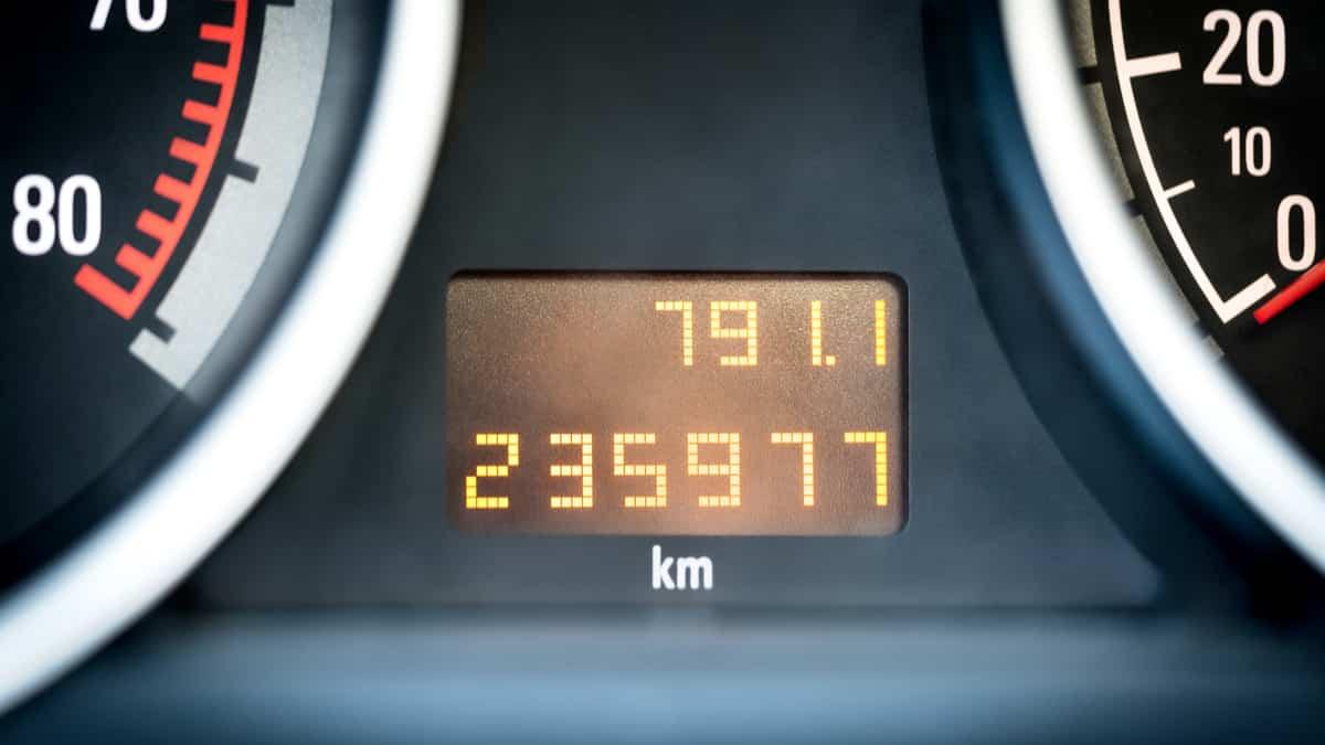 A close-up view of a car's odometer showing high mileage, symbolizing vehicle usage over time.