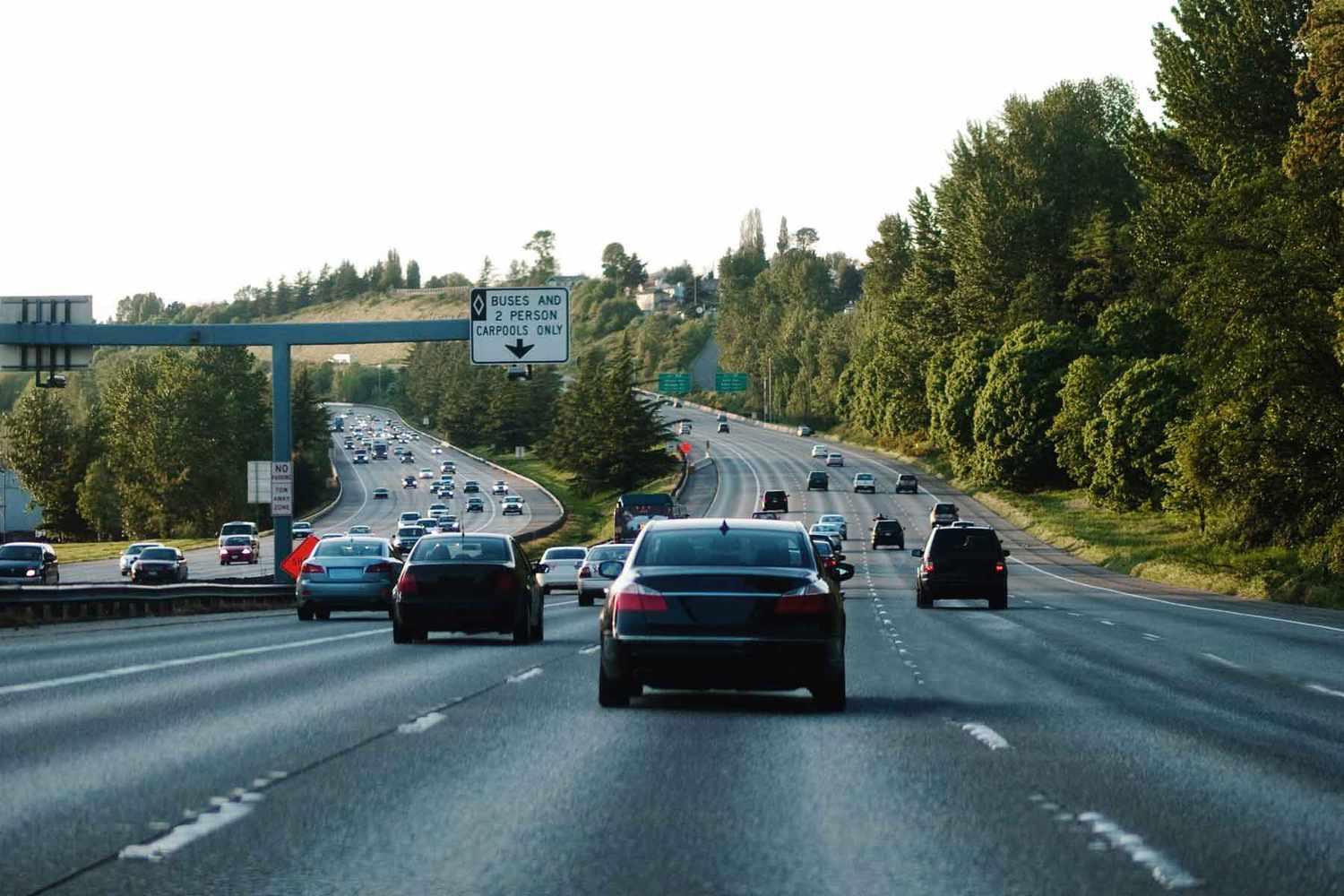 Cars cruising on a highway with multiple lanes, illustrating the steady speeds of highway driving.