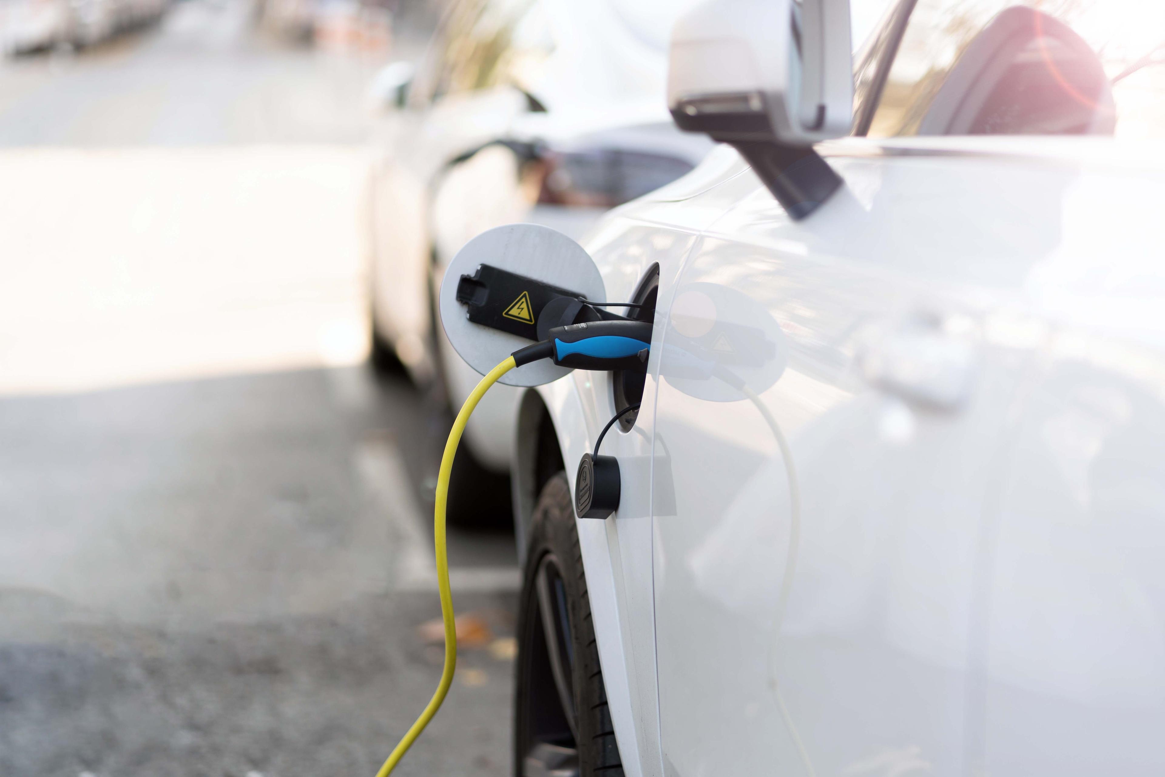 Advantages and Disadvantages of Buying an Electric Vehicle Electric Vehicle getting charged at an Electric Vehicle Charging Station