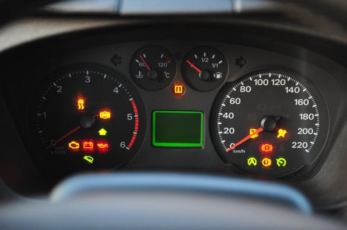 Illuminated dashboard warning lights in a car, helping drivers understand key maintenance and safety alerts.