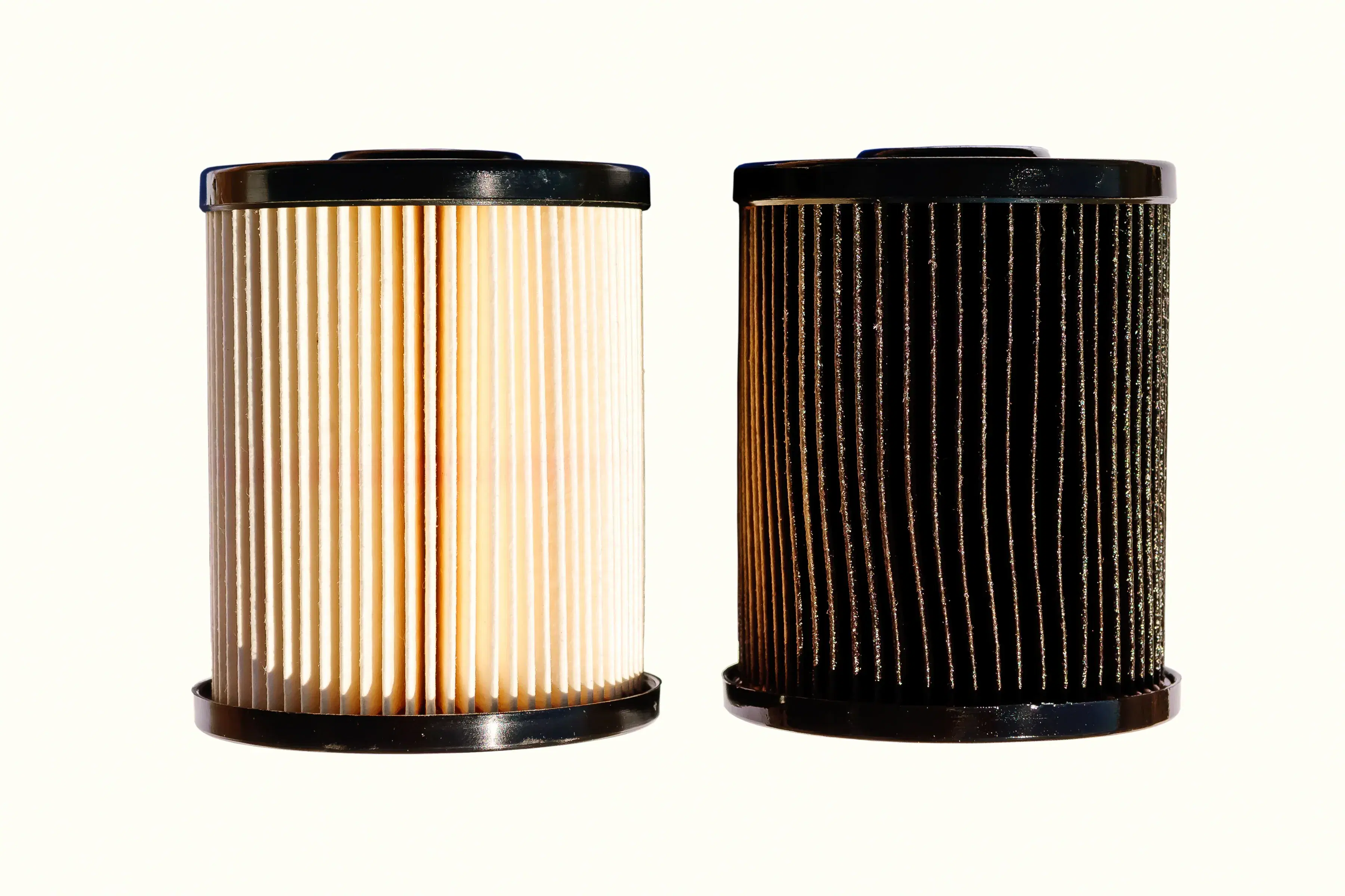 Side-by-side comparison of a clean fuel filter and a clogged and dirty fuel filter.